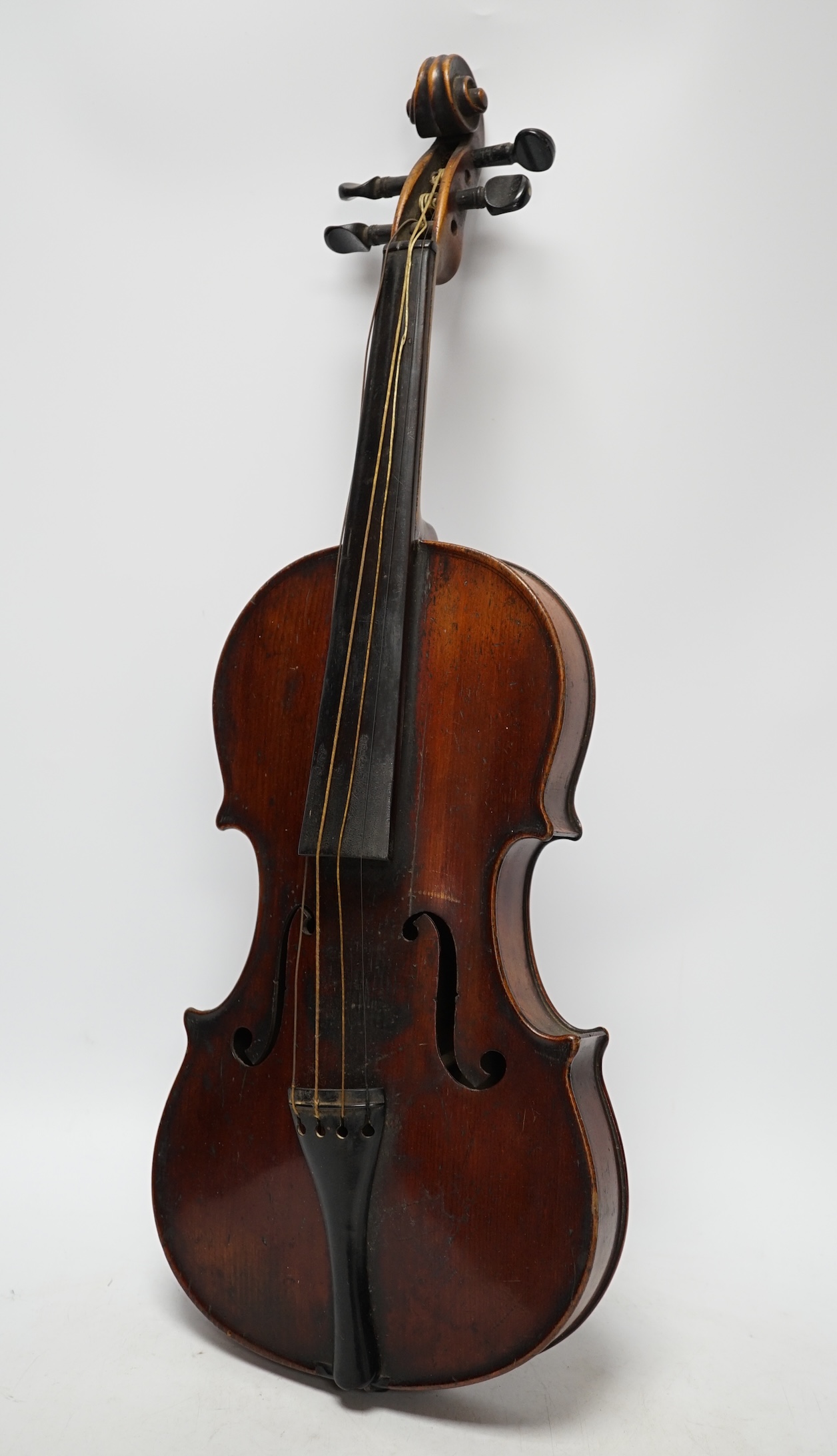 A late 19th century three quarter length violin with label; 'Medio-Fino', back measures 33cm. Condition - fair